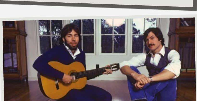 Steve Wozniak playing guitar beside Steve Jobs