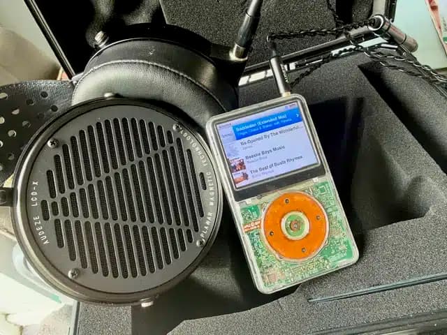 Audeze LCD-X headphones alongside a modified iPod in their travel case