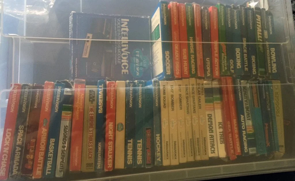 A crate filled with boxed Intellivision games