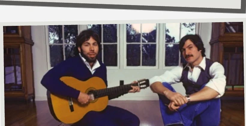 Steve Wozniak playing guitar beside Steve Jobs
