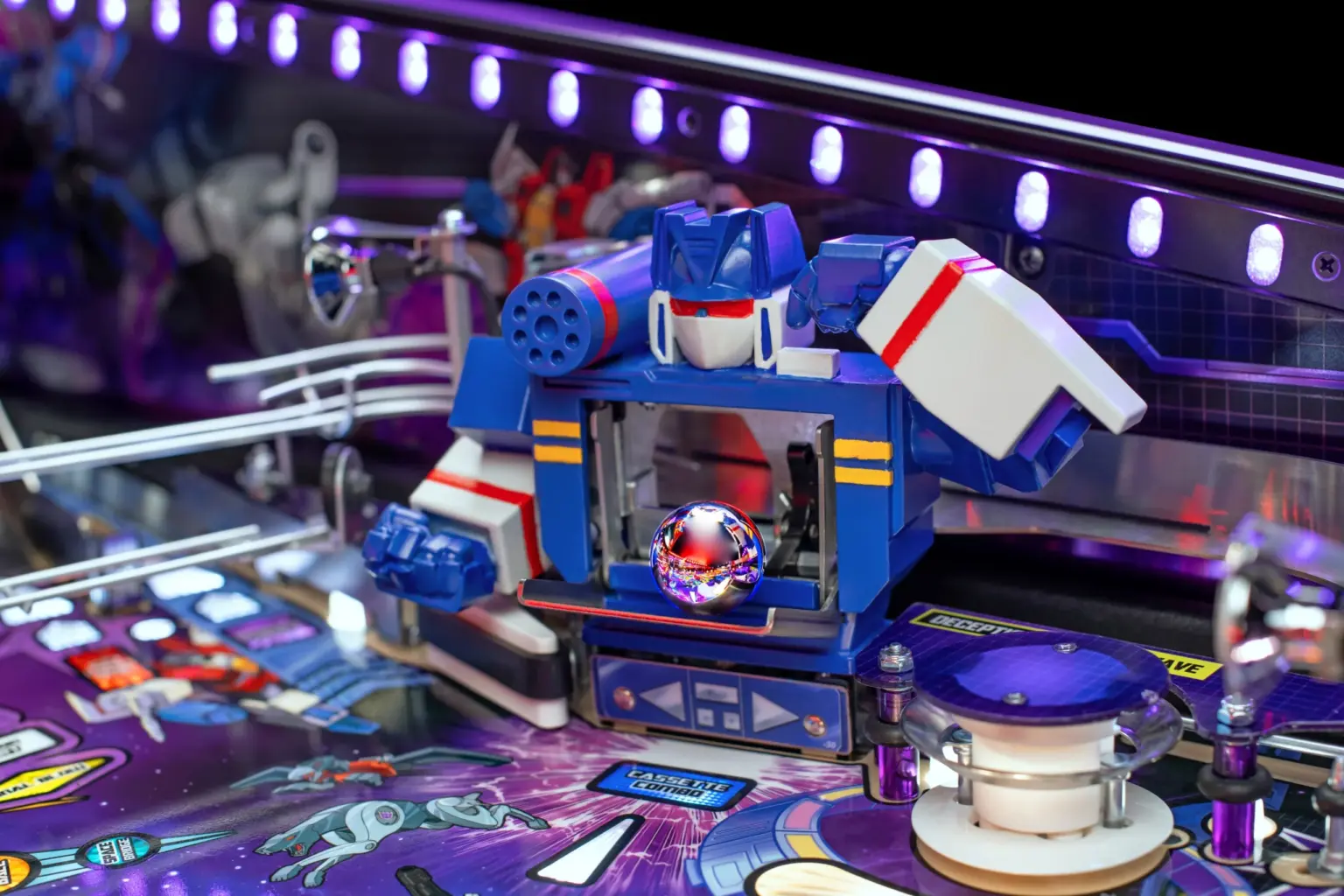 A Soundwave figure surrounding the steel ball on Stern’s Transformers pinball playfield