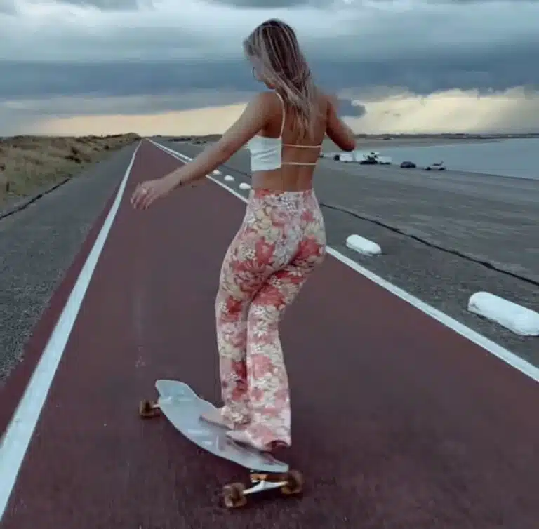 Sterre Meijer longboarding along a coastal road