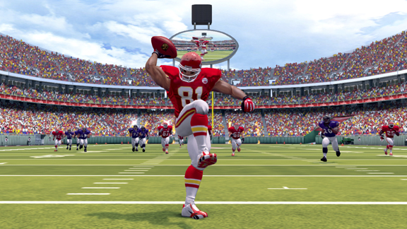 An NFL Blitz player running with the football in a stadium