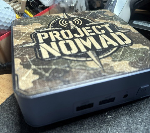 A Geekom mini PC custom printed with Project Nomad artwork